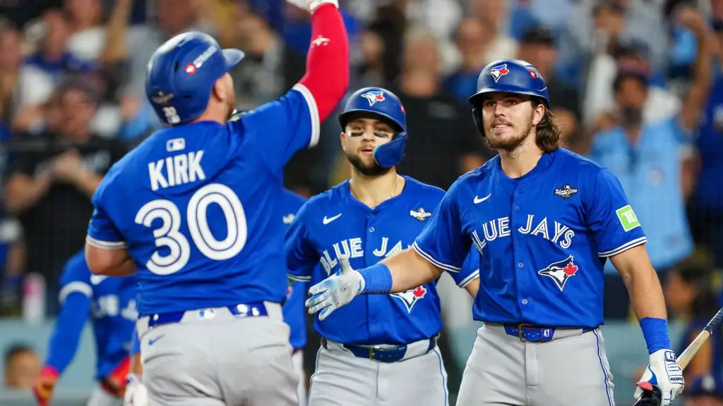 Toronto Blue Jays catcher Alejandro Kirk (left) celebrates with team-mates after hitting a three-run home run in game three of the World Series